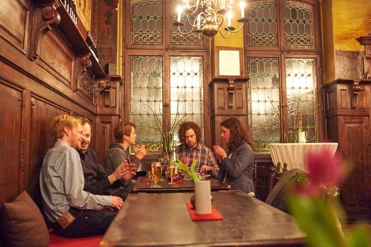 Gäste sitzen gemütlich im Rittersaal bei Speisen, Wein und Bier - Restaurant Ritter Fulda
